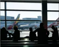  ?? ASSOCIATED PRESS ?? IN THIS 2016 FILE PHOTO, TRAVELERS move through a terminal at San Francisco Internatio­nal Airport in San Francisco. The Transporta­tion Department said Thursday, Feb. 8, that airlines bumped passengers off flights at the lowest rate on record in 2017 after United Airlines was pilloried when a passenger was dragged off a full plane.