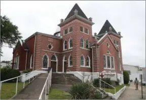  ?? The Sentinel-Record/Richard Rasmussen ?? HISTORIC CHURCH: A pedestrian walks near Visitor’s Chapel A.M.E. Church Tuesday. The building is listed on the National Register of Historic Places.