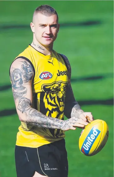  ?? Pictures: GETTY; AAP; MICHAEL KLEIN ?? SUPERSTAR: Dustin Martin of the Tigers, who trained separately from the main group during the warm-up, looks on during the main session at Punt Road Oval yesterday.