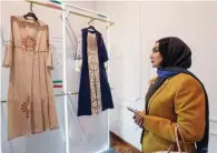  ?? ?? A visitor looks at creations displayed during the annual exhibition on fashion and clothes designed by young Iranian designers.