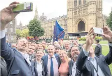  ??  ?? ONE OUT, ALL OUT Blackford’s colleagues walk out of the chamber after he is expelled. Outside, the group pose for selfies with their Westminste­r leader