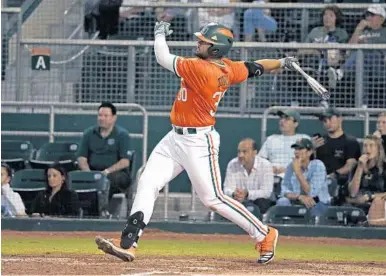  ?? DAVID SANTIAGO/AP ?? Miami’s Alex Toral follows through on a three-run homer on Feb. 19 in Coral Gables. Toral, an Archbishop McCarthy graduate, is one of several Broward and Palm Beach County players looking to be picked in this year’s MLB Draft.