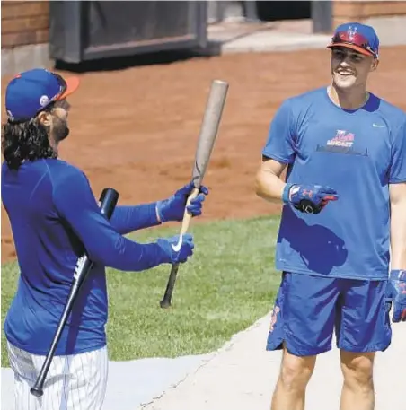 ?? AP ?? Brandon Nimmo (r.) with Jake Marisnick says coronaviru­s testing is going well for Mets while other teams struggle.