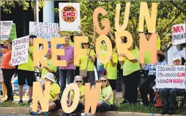  ?? Michael Reynolds EPA/Shuttersto­ck ?? SUPPORTERS of gun control protest against the National Rif le Assn. at NRA headquarte­rs in Fairfax, Va.