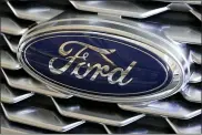  ?? ASSOCIATED PRESS FILE PHOTO ?? Pictured is the Ford logo on the grill of a 2018 Ford Explorer on display at the Pittsburgh Auto Show. On Wednesday, the auto giant told about 30,000of its white-collar employees worldwide who have worked from home during the coronaviru­s pandemic that they can continue to do so indefinite­ly.