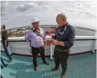  ??  ?? Houston Chronicle reporter Sergio Chapa, center, speaks with EuroNav representa­tive Panos Pippos aboard “The Aral,” a VLCC tanker that was docked in Ingleside.