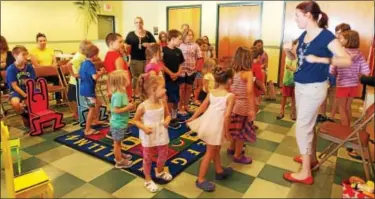  ?? LISA MITCHELL — DIGITAL FIRST MEDIA ?? Julie Keller, a music therapist from Wyomissing, got children moving to music at Kutztown Community Library July 21.