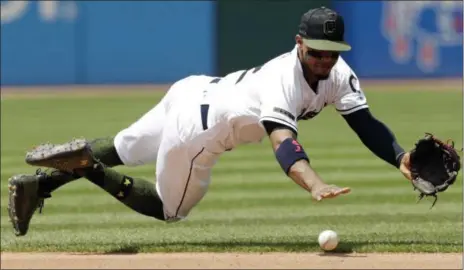  ?? TONY DEJAK — ASSOCIATED PRESS ?? Francisco Lindor dives for a ball hit by the Astros’ Jose Altuve in the fourth inning May 27 at Progressiv­e Field. Altuve was safe at first base.