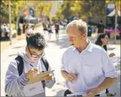  ?? Kent Nishimura Los Angeles Times ?? ACTIVIST Tom Steyer helps Kevin Huy Nguyen register to vote at Cal State Fullerton on Oct. 10.