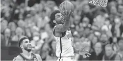  ?? STEVEN SENNE/AP ?? Nets guard Kyrie Irving drives to the basket past Celtics forward Jayson Tatum during Game 1 of a first-round playoff series Sunday in Boston. The Celtics won 115-114.