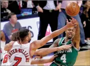  ?? AP/CHARLES REX ARBOGAST ?? Isaiah Thomas (right) of the Boston Celtics passes under pressure from Michael Carter-Williams (7) and Robin Lopez of the Chicago Bulls during Friday’s NBA Eastern Conference playoff game. Boston won 104-87 and trails 2-1 in the series.
