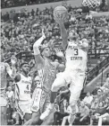  ??  ?? Florida State guard Trent Forrest, right, shoots against North Carolina forward Garrison Brooks Monday night in Tallahasse­e, Fla.