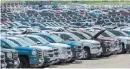  ?? TIJANA MARTIN THE CANADIAN PRESS ?? Vehicles sit in a lot at the General Motors assembly plant in Oshawa, where GM is recalling workers laid off because of a strike in the United States.