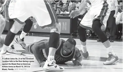  ??  ?? LeBron James No. 23 of the Cleveland Cavaliers falls to the floor during a game against the Miami Heat at American Airlines Arena on March 16, 2015 in Miami, Florida.