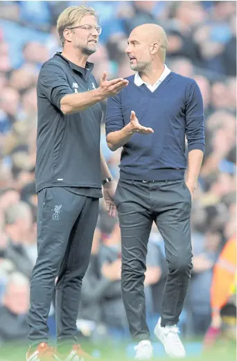  ??  ?? Liverpool manager Juergen Klopp, left, talks to Manchester City boss Pep Guardiola.