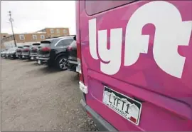  ?? David Zalubowski Associated Press ?? LYFT has contribute­d more than $45 million to the campaign in support of Propositio­n 30. Above, vehicles in its ride-hailing f leet sit in a lot in Denver in 2020.