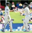  ??  ?? Jeet Raval, left, touches gloves with Kane Williamson during his test debut against Pakistan in Christchur­ch in 2016.