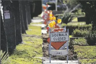  ?? DAMIAN DOVARGANES/AP ?? A SIDEWALK IS CLOSED as crews work on repairs in Upland, Calif., on Monday.