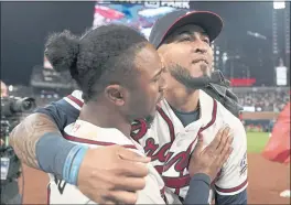  ?? BRYNN ANDERSON — THE ASSOCIATED PRESS ?? NLCS MVP Eddie Rosario, right, celebrates with Braves teammate Ozzie Albies after Saturday night’s pennant-winning Game 6 victory over the Los Angeles Dodgers.