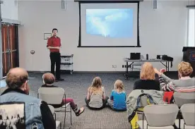  ?? PHOTOS BY DAVE JOHNSON THE WELLAND TRIBUNE ?? Storm chaser David Chapman takes children, and some parents and grandparen­ts, on a storm chasing journey during a presentati­on Thursday at Welland Public Library.