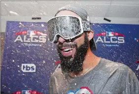  ?? DAVID J. PHILLIP/AP PHOTO ?? David Price enjoys a champagne shower after he pitched six shutout innings to help the Red Sox beat the Astros 4-1 on Thursday night in Houston and advance to the World Series starting Tuesday night at Fenway Park in Boston.