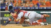  ?? Bob Levey Getty Images ?? MYLES STRAW of Houston scores past Francisco Arcia on a safety squeeze by Jake Marisnick.