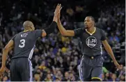  ?? — AP ?? Golden State Warriors’ Kevin Durant (right) celebrates in their NBA game against New Orleans Pelicans on Saturday.