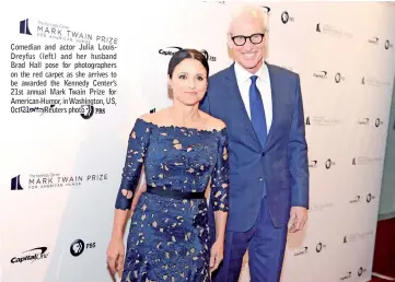  ??  ?? Comedian and actor Julia LouisDreyf­us (left) and her husband Brad Hall pose for photograph­ers on the red carpet as she arrives to be awarded the Kennedy Center’s 21st annual Mark Twain Prize for American Humor, in Washington, US, Oct 21. — Reuters photo