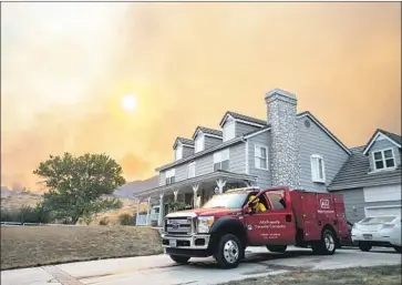  ?? Stuart Palley For The Times ?? A PRIVATE fire crew for the insurance company AIG arrives to protect a home during the 2016 Sand fire in the Santa Clarita area. Some fire department­s say private forces don’t always coordinate with public agencies.