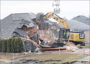  ?? Clarence Tabb Jr. Detroit News ?? A BROKEN sewer line that created a sinkhole necessitat­ed the demolition of this house last year in Fraser, Mich. Manufactur­ing is booming in the area, but roads and infrastruc­ture are in dire need of upgrade.