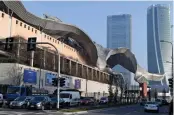  ?? — AFP ?? Cars drive past MiCO (left), the largest convention centre in Europe, with the Allianz tower (centre) and Zaha Hadid’s Generali tower (right) visible in the background in Milan.