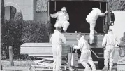  ?? MASSIMO PAOLONE AP ?? Coffins are removed Saturday at the Ferrara cemetery in northern Italy from a military convoy coming from Bergamo, a city at the epicenter of the virus outbreak.