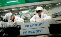  ?? PHOTO: REUTERS ?? Employees work inside a Foxconn factory in the township of Longhua in the southern Guangdong province.
