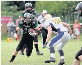  ?? Tim Furfie ?? Halton Spartans running back Alex Martin looks to move the ball upfield against the Leeds Bobcats.