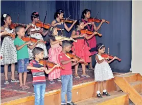  ??  ?? The young violinists at a recent performanc­e. Pic by Studio Colour Dreams