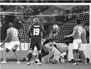  ??  ?? Real Madrid’s defender Sergio Ramos (centre) scores during the UEFA Champions League football match SSC Napoli vs Real Madrid at the San Paolo stadium in Naples. — AFP photo