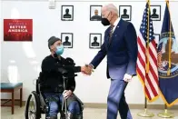  ?? The Associated Press ?? ■ President Joe Biden shakes hands with veteran John Caruso as Biden tour’s the Fort Worth VA Clinic in Fort Worth, Texas, on March 8. Biden signed veterans health care legislatio­n on Wednesday that ends a long battle to expand benefits for people who served near burn pits. It’s a personal issue for Biden. His son Beau was a major in the Delaware Army National Guard, and he died of cancer after his service in Iraq.