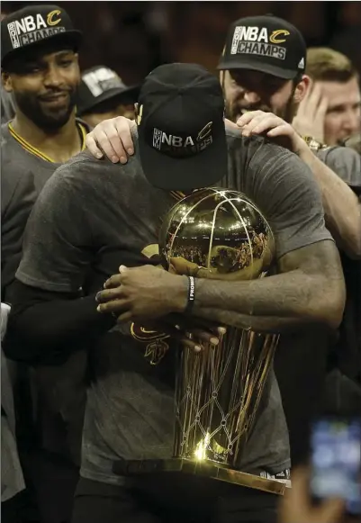  ?? PHOTO ?? Cleveland Cavaliers forward LeBron James (center) celebrates with teammates after Game 7 of basketball's NBA Finals against the Golden State Warriors on Sunday in Oakland. AP