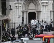  ??  ?? Police officers work at the scene of a knife attack Thursday at Notre Dame church in Nice, southern France. (AP/Daniel Cole)