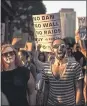  ?? ANDRES KUDACKI — AP ?? People protest at a rally in New York Tuesday about the Supreme Court’s decision to uphold President Donald Trump’s travel ban on many mostly Muslim countries.