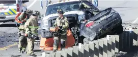  ?? DARREN MAKOWICHUK ?? Rescue workers investigat­e a collision on Highway 22 near Priddis.