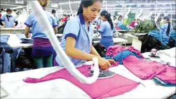  ?? PHA LINA ?? A worker irons clothing at a factory in Phnom Penh in June 2013.