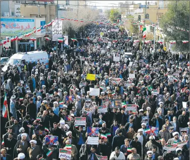  ?? AP/ Tasnim News Agency/MOHAMMAD ALI MARIZAD ?? Demonstrat­ors, mostly clerics, attend a pro-government rally Wednesday in the holy city of Qom south of the capital Tehran, Iran.