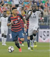  ?? JESSICA HILL/THE ASSOCIATED PRESS ?? The United States’ Dom Dwyer, left, is pursued by Ghana’s Isaac Sackey on Saturday during the second half of an internatio­nal friendly in East Hartford, Conn.