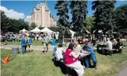  ?? GREG PENDER/STAR PHOENIX ?? A busy lunch crowd relaxes in the sunshine during the 2014 Taste of Saskatchew­an in Kiwanis Park.