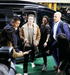  ?? — AFP photo ?? Zuckerberg (centre) arriving at the undergroun­d parking lot of LG Twin Tower during his visit to South Korea on the second leg of his Asia trip in Seoul.