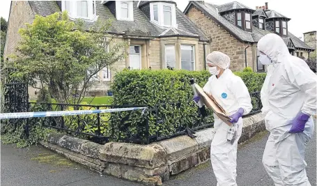  ?? Picture: SWNS. ?? Forensic officers at Arnold Mouat’s home in Bo’ness, West Lothian, where a body was discovered on Saturday.