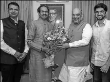  ?? PTI FILE ?? BJP president Amit Shah with Shiv Sena chief Uddhav Thackeray and Maharashtr­a CM Devendra Fadnavis on Wednesday.