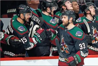  ?? AP-Ross D. Franklin ?? Coyotes defenseman Alex Goligosk celebrates his goal against the Devils with Coyotes’ Brad Richardson during the first period in Glendale, Ariz., on Saturday.