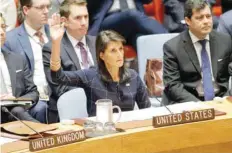 ?? — AFP ?? United States Ambassador to the United Nations Nikki Haley rises her arm as she votes at a UN Security Council meeting over North Korea’s new sanctions at the UN Headquarte­rs in New York.